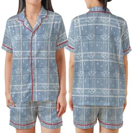 Celestial Dreamer's Stylized Closed Eye & Crescent Moon Design: Muted Dusty Blue Tartan Plaid Satin Short-Sleeve Pajamas Set