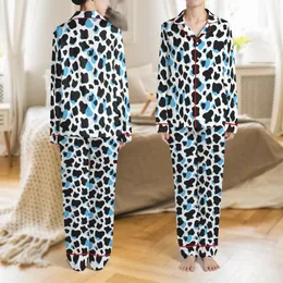 Dynamic Cow Print Design: Bold Black Organic Spots with Layered Vibrant Blue Shapes on White Satin Pajamas Set