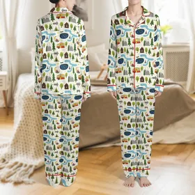 Outdoor Enthusiasts' Whimsical Forest Camping Pattern: Green Pines, Cabins, Campfires, RVs & Mountains on Creamy Off-White Satin Pajamas Set
