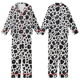 Animal Print Lovers' Bold Black White Organic Cow Pattern with Subtle Light Blue Accents Kid Satin Pajamas Set