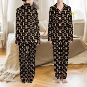 Quirky Animal Lovers' Warm Brown Grumpy Cartoon Highland Cow Calves All-Over Pattern with 'Moo.' Text on Solid Black Background Satin Pajamas Set