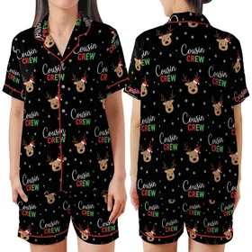 Cousin Crew Festive Graphic: Playful Cartoon Reindeer, Santa Hats & Snowflakes - Black Family Print Satin Short-Sleeve Pajamas Set