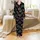 Holiday Revelers' Playful 'Most Likely To' Christmas Phrases, Minimalist Santa Hats, Snowflakes, Stars on Black Satin Pajamas Set - 2