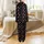 Women's Festive Black Pajama Set: 'Believe' Script, Santa Hat, & Snowflake Pattern Satin Pajamas Set - 3