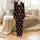 Brown Highland Cows: Red Santa Hats, Plaid Scarves, Snowflakes, Candy Canes Pattern on Black Satin Pajamas Set - 2