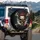 Menacing Grinning Cracked Skull with Glowing Cigar Crossed Bones - Rebel Lifestyle Spare Tire Cover - 3