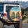 Smiling Skeletal Figures Driving Long Desert Highway - Adventure Road Trip Gift Spare Tire Cover - 3