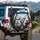 Rabbits Driving Car Cityscape - Outdoor Adventure Gift for Animal Lovers Spare Tire Cover - 3