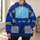 Retro mechanical-character costume surface with a blue body Cyan Chest Screen Yellow Bars and gray segmented panels. All-over Print Hoodie (Lightweight) - 6