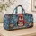 Penguin Holding a Gift in Winter Snow for Cozy Holiday Travel and Seasonal Getaways Quilted Weekend Bag - 4