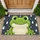 Cute Green Frog in a Rain Shower for Cheerful Nature-Inspired Home Entryways and Cozy Spaces Doormat - 1