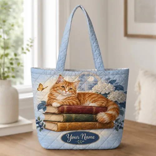 Ginger Cat Resting on Vintage Books for Cozy Reading Days and Cat Lover Gifts Quilted Tote Bag